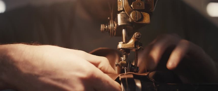 Traditional bespoke shoemaker stitching sewing leather upper old sewing machine close up
