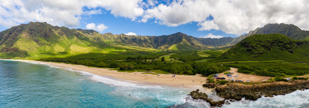 Broad panorama of Makua beach and valley from aerial view over the ocean on west coast of Oahu, Hawaii
