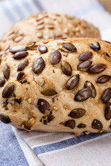 Gold rustic crusty loaves of bread and buns on wooden background. Still life captured from above top view, flat lay.