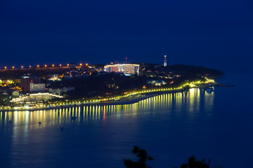 Gelendzhik Bay, Thick Cape and Gelendzhik lighthouse in the evening twilight from a bird's eye view.  lights of the embankment are reflected in the Bay.