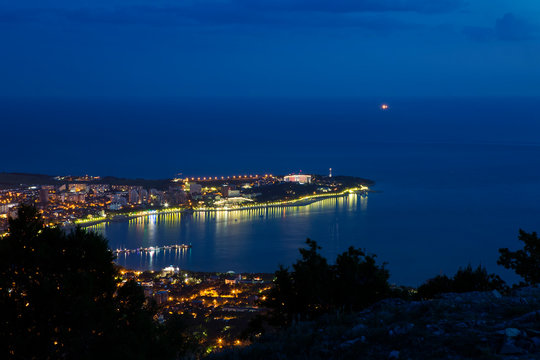 Gelendzhik Bay, Thick Cape and Gelendzhik lighthouse in the evening twilight from a bird's eye view.  lights of the embankment are reflected in the Bay.