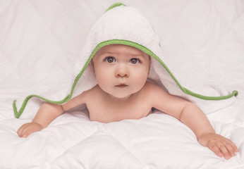 Sweet little baby boy portrait with towel on his head, on white background