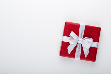 Gift or present box and stars confetti on color table top view. Flat lay composition for birthday, mother day or wedding.