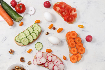 Useful breakfast, fried bread, carrots and cucumbers, tomatoes and radishes, eggs, green sandwiches, fermented foods, the concept of a healthy diet and weight loss, diet mini-sandwiches 