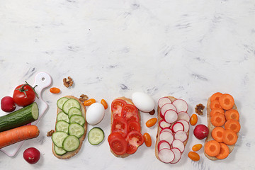 Useful breakfast, fried bread, carrots and cucumbers, tomatoes and radishes, eggs, green sandwiches, fermented foods, the concept of a healthy diet and weight loss, diet mini-sandwiches 