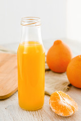 Tangerine juice in a bottle.