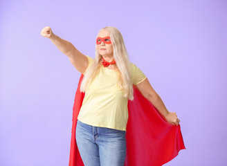 Woman in superhero costume on color background. Concept of feminism