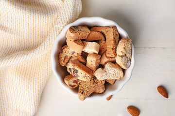Bowl with sweet cookies on table