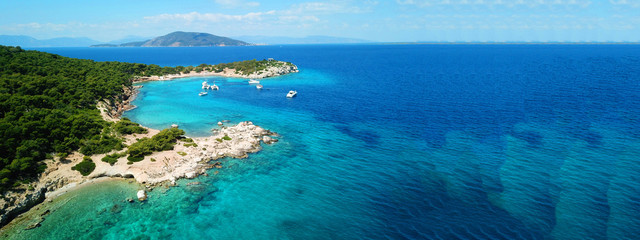 Aerial drone ultra wide photo of paradise small island of Moni visited by sail boats and yachts...