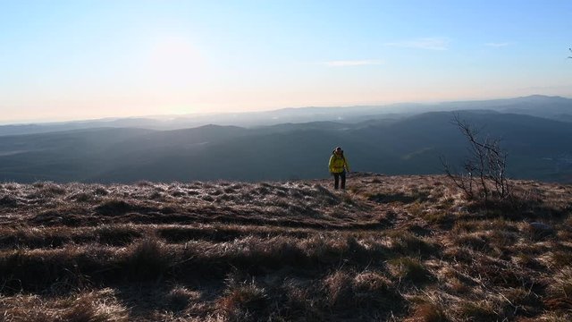 TS Woman hiking in sunshine on a windy day