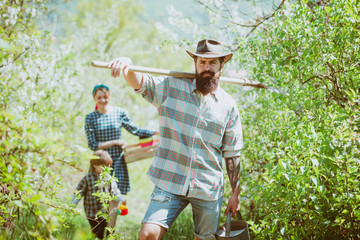 Family planting. Family with his son working on organic farm in spring.