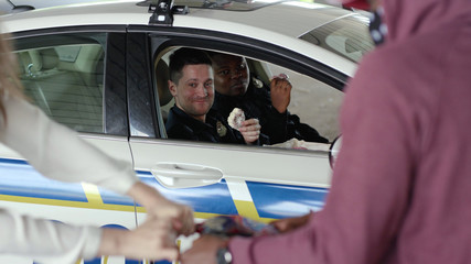 Slow motion two policemen eating donut smile talk see how a man steals a woman's bag near patrol...