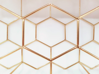 Geometric pattern of hexagons made of metal in gold color on a white background. Concept background, abstraction