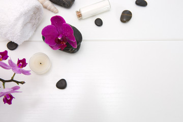 Obraz na płótnie Canvas Spa setting with pink orchids, black stones and bath salts on white .
