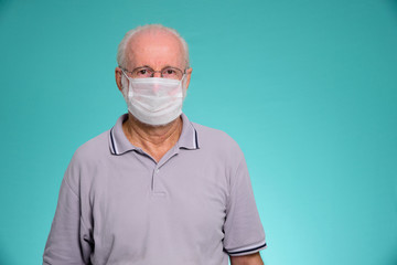 Portrait of senior brazilian man using medicine healthcare mask for health medical care, protect Covid-19 and Air pollution pm2.5 on a green background.