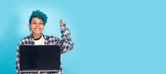 afro american girl with laptop computer isolated on blue background