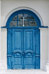 Beautiful blue wooden door at the entrance to the Orthodox church.