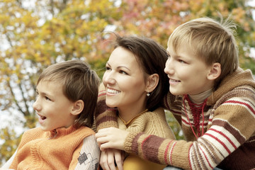 Fototapeta premium Happy mother and sons in the autumn park
