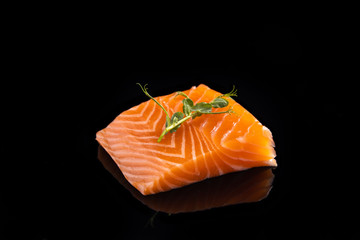  fresh salmon and microgreens on a black background for the menu