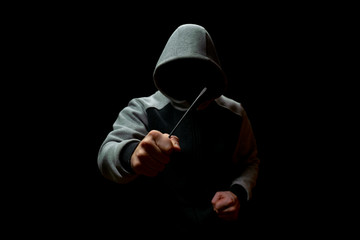 Unknown maniac with a screwdriver in his hand, on a black background