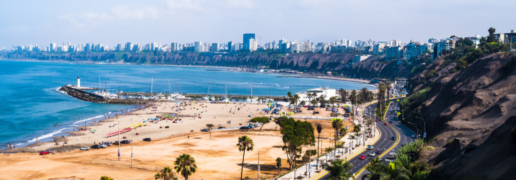 Panoramic aerial view of Sombrillas beach and the Costa Verde of Lima as background.