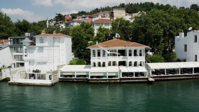 Waterside Houses and Boat Passing Aerial View