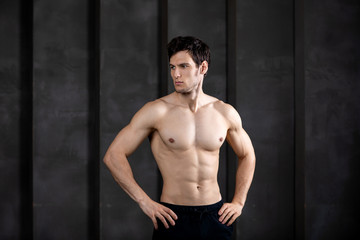 Fototapeta na wymiar Portrait of muscular guy posing in a studio.