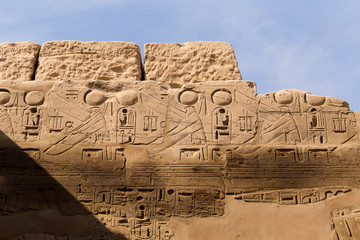 Karnak Temple, complex of Amun-Re. Embossed hieroglyphics on walls. Luxor Governorate, Egypt.
