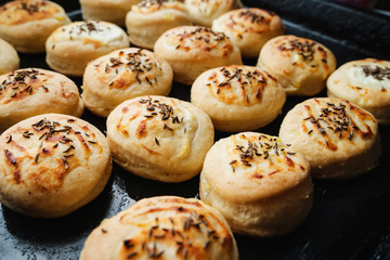 Homemade Cheese Scones with Caraway meridian fennel Persian cumin egg glazed baked buns in a black casserole fresh