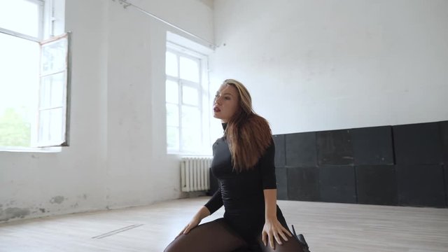Young adult woman showing erotic dancing style in choreography studio