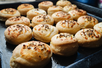 Homemade Cheese Scones with Caraway meridian fennel Persian cumin egg glazed baked buns in a black casserole fresh