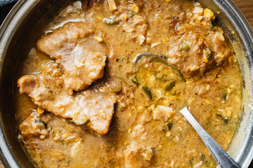 High angle view on pork meat stew with mushrooms and pickles in a tasty sauce homemade cooked high angle view