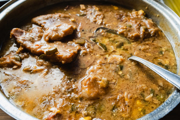 High angle view on pork meat stew with mushrooms and pickles in a tasty sauce homemade cooked high angle view