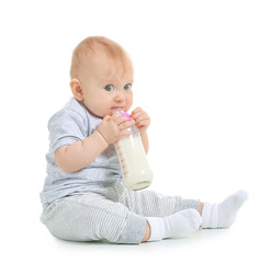 Baby with bottle of milk on white background