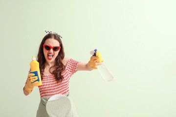 Funny housewife on color background