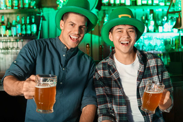 Young friends celebrating St. Patrick's Day in pub