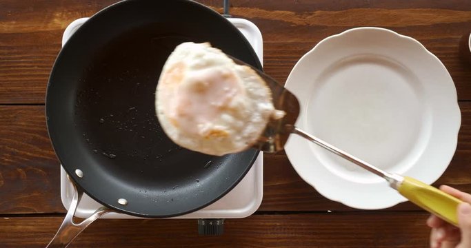 Top view food. Cooking With Mother. Beautiful Little Girl Learns How To Make Fried Egg.