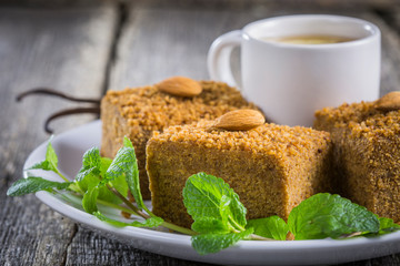 Vegan pie Medovik with a cup of tea close-up