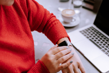 partial view of woman checking smartwatch