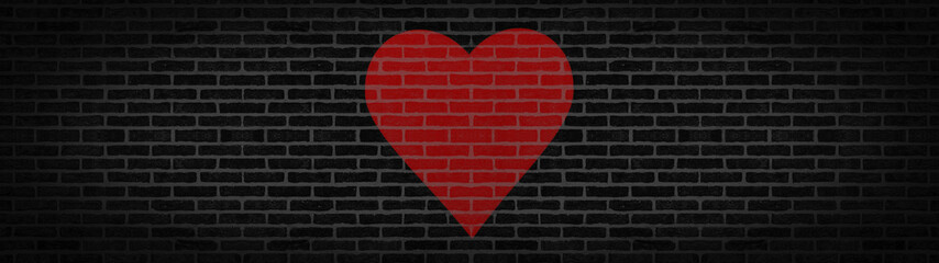 Dark black anthracite rustic brick wall texture with red heart banner panorama