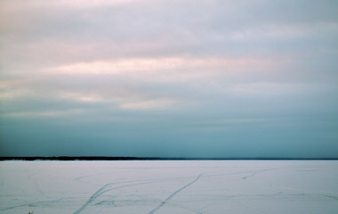 sunset in winter over a frozen river