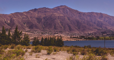 Fototapeta na wymiar Ciudad rodeada de un lago y una montaña, Argentina