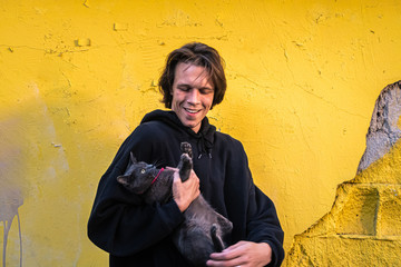 funny guy with a seal on his hands.yellow background