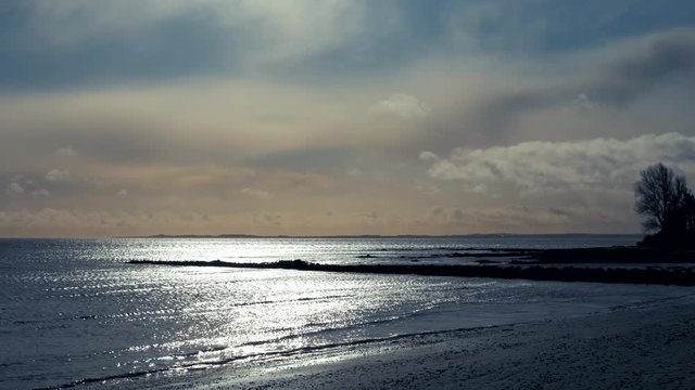 Serene morning beach with shimmering sea