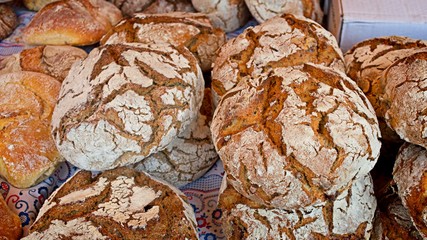 Stack of round rustic bread rolls in a portuguese market. Tasty meal.