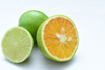 Tahiti lemons and whole and sliced oranges