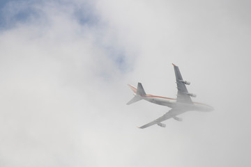 The plane that enters the clouds in the sky.