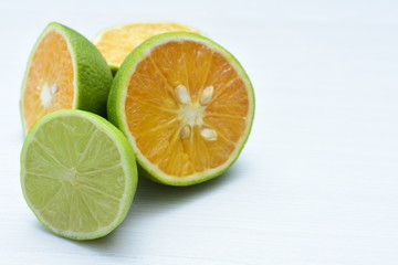 Tahiti lemons and whole and sliced oranges