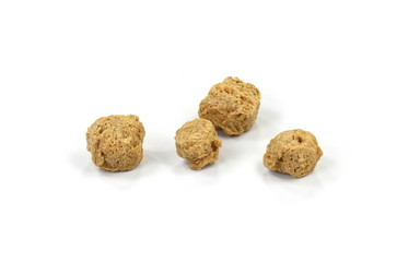 Raw dehydrated soy meat on white background. Pieces of dry soy meat. Textured Soy Protein.