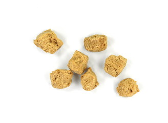 Raw dehydrated soy meat on white background. Pieces of dry soy meat. Textured Soy Protein.